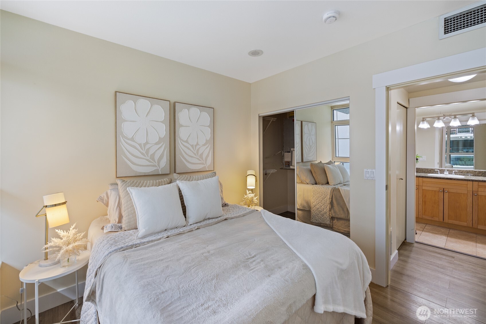 1420 Terry Avenue, Unit 607 Seattle, WA 98101 - Photo 18 of 40 a bedroom with a large bed and a chandelier