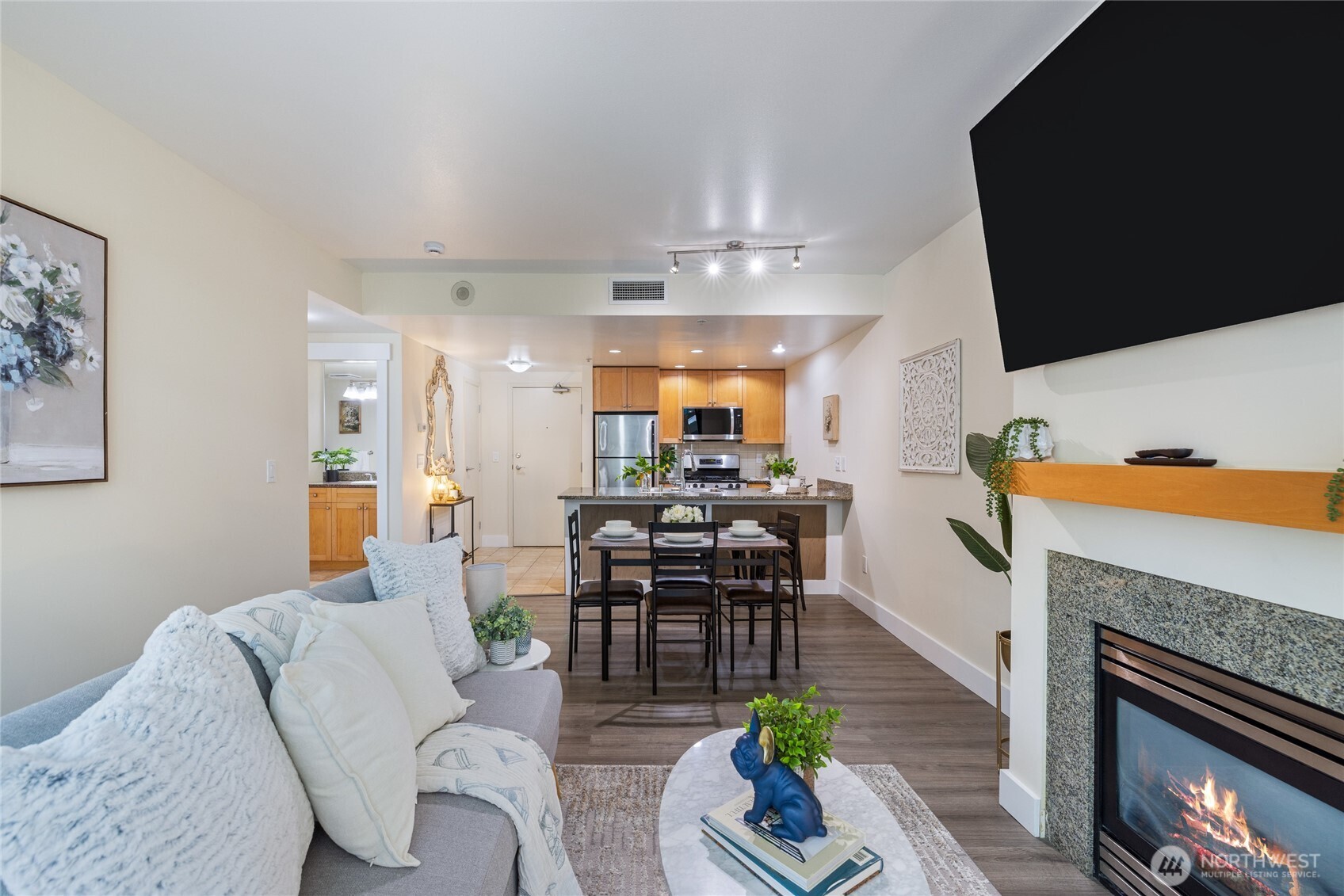 1420 Terry Avenue, Unit 607 Seattle, WA 98101 - Photo 2 of 40 a living room with furniture a fireplace and a flat screen tv