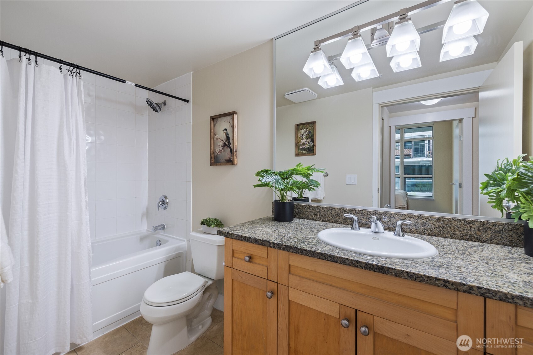 1420 Terry Avenue, Unit 607 Seattle, WA 98101 - Photo 21 of 40 a bathroom with a granite countertop sink toilet and shower