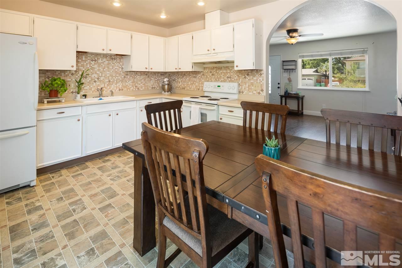2865 Judith Lane Reno, NV 89503 - Photo 4 of 13 a kitchen with stainless steel appliances kitchen island granite countertop a sink and cabinets