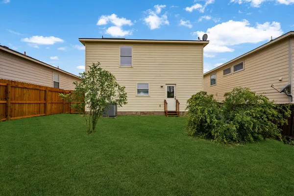 a view of a backyard with plants and a backyard