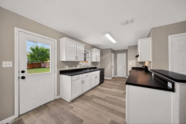 a kitchen with granite countertop a refrigerator and a stove
