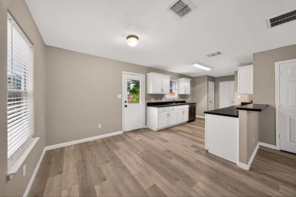 a kitchen with white cabinets and white appliances