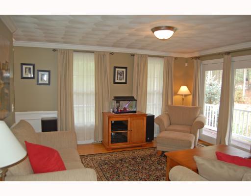 69 Olney Keach Road Glocester, RI 02814 - Photo 7 of 12 Living Room. Wainscoting, crown molding, chair rail and hardwood floors. Who could ask for more? No one! But there is; including French doors that open to the wrap around farmerrs porch, a stunning view of the surrounding woods and much much more!