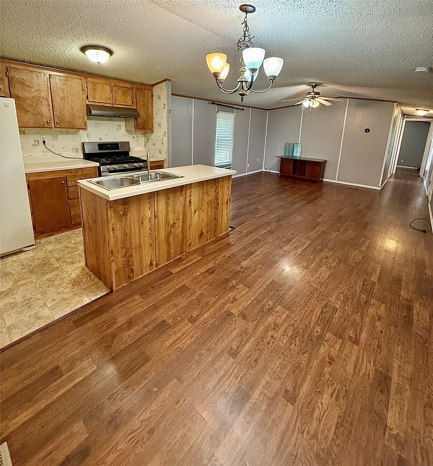 3075 FM 2001 Buda, TX 78610 - Photo 7 of 26 A functional kitchen with a kitchen island overlooking and open to the living area.