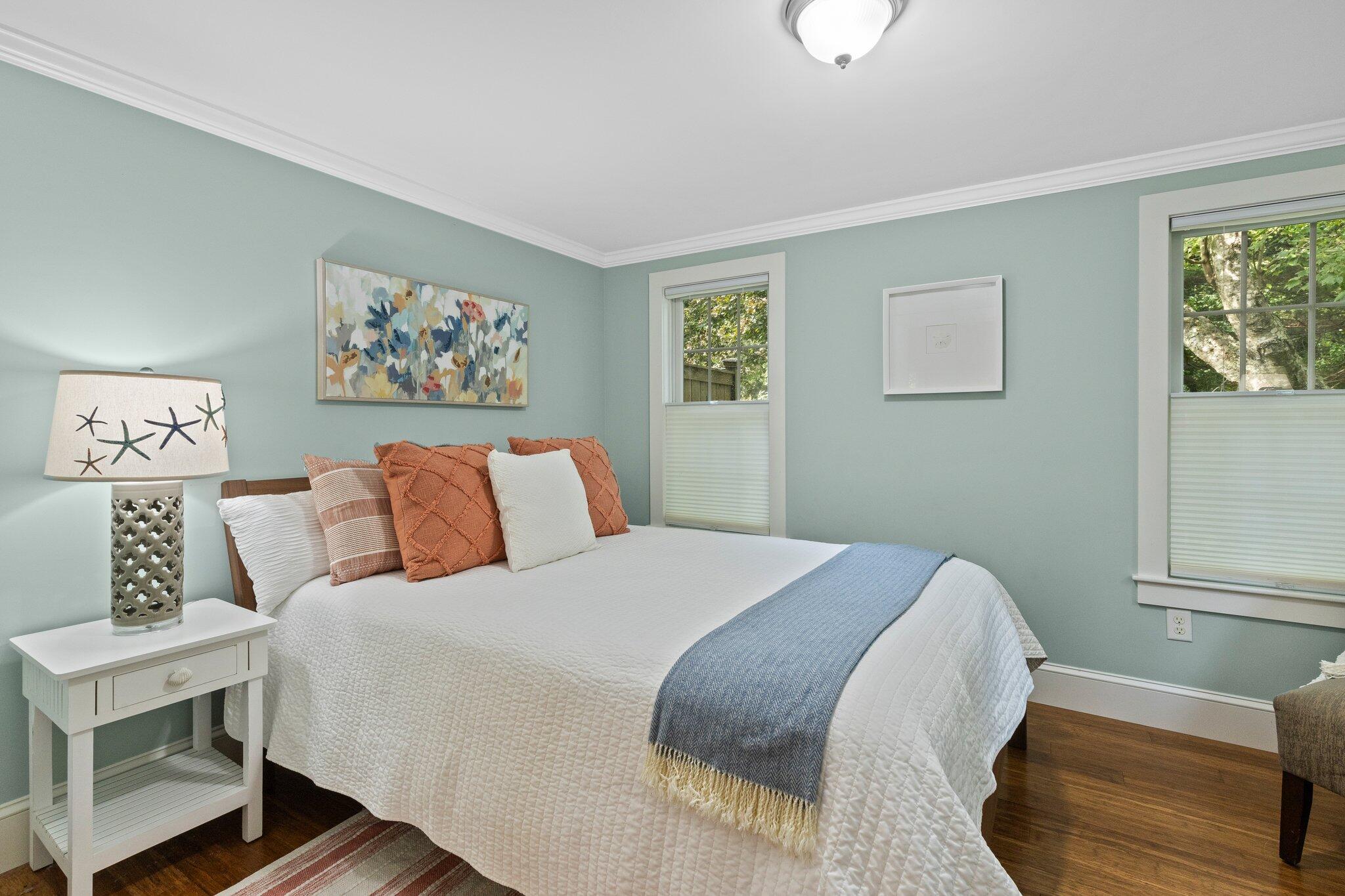 96 Pochet Road Orleans, MA 02653 - Photo 11 of 55 a bedroom with a bed and a painting on the wall