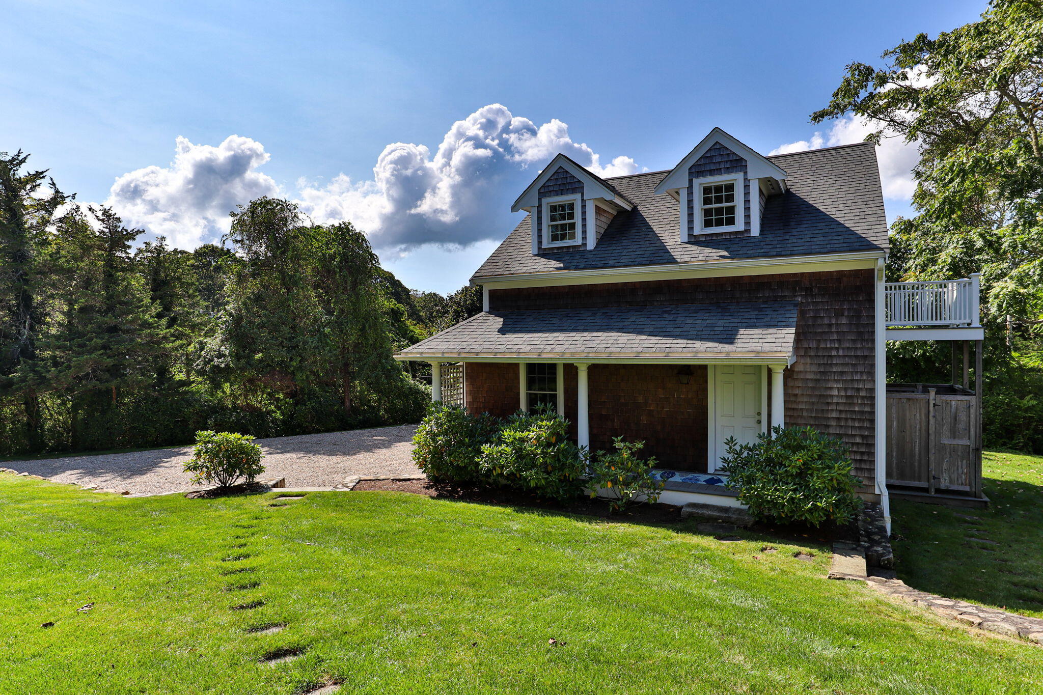 96 Pochet Road Orleans, MA 02653 - Photo 3 of 55 a front view of a house with a yard and garage