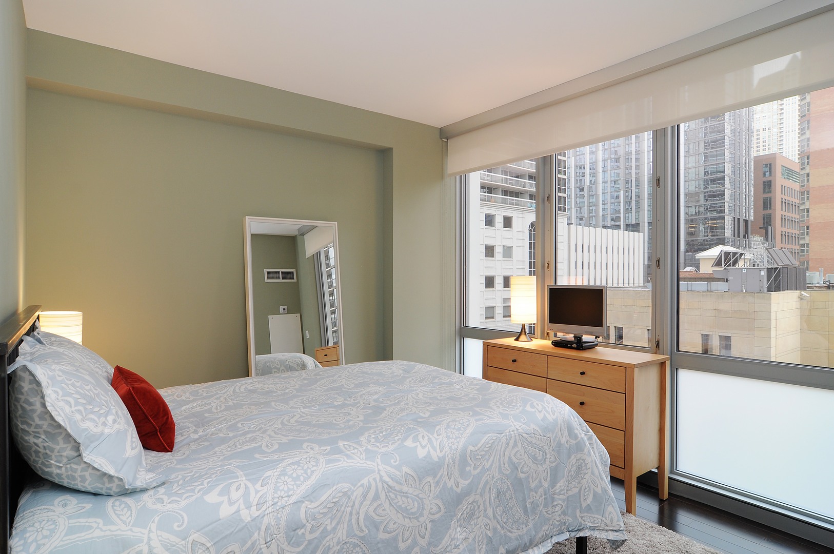 2 West Delaware Place, Unit 504 Chicago, IL 60610 - Photo 12 of 24 a bedroom with a bed and a flat tv screen next to a window