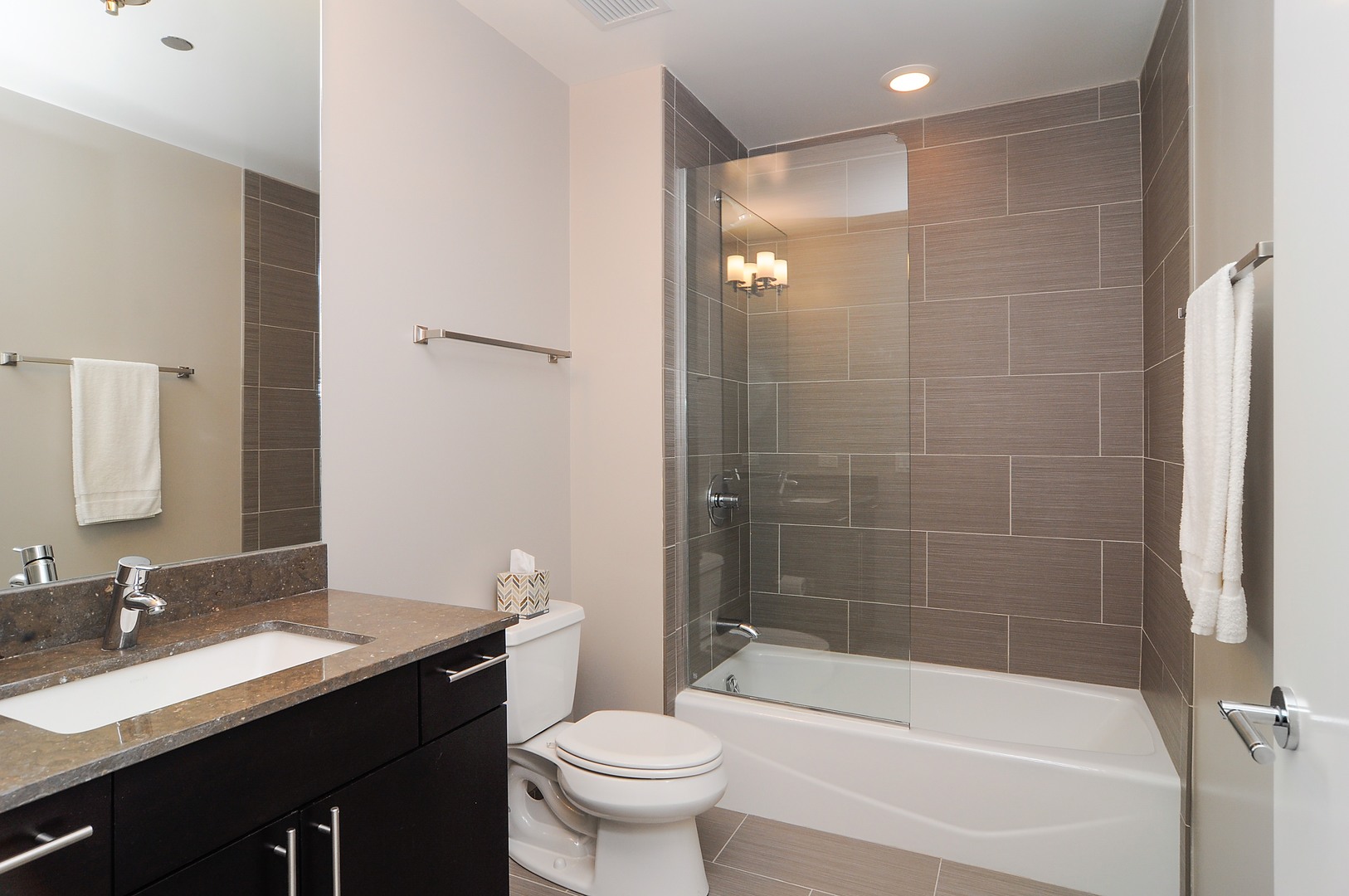2 West Delaware Place, Unit 504 Chicago, IL 60610 - Photo 14 of 24 a bathroom with a bathtub shower sink mirror and toilet