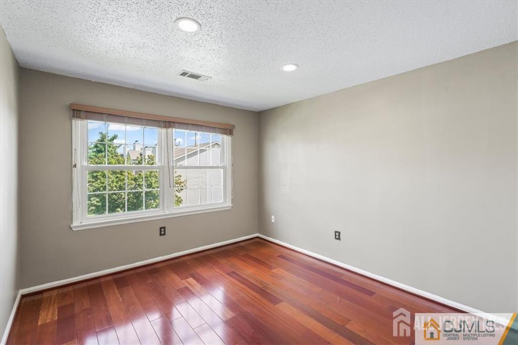 834 Edpas Road New Brunswick, NJ 08901 - Photo 5 of 20 an empty room with wooden floor and windows