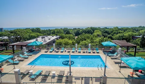 a view of a swimming pool and lounge chairs in patio