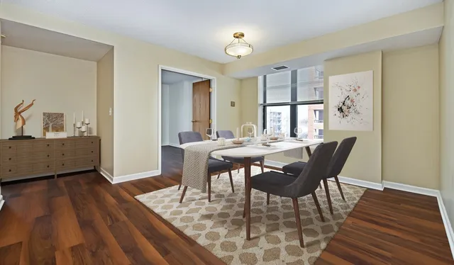 a view of a dining room with furniture and wooden floor