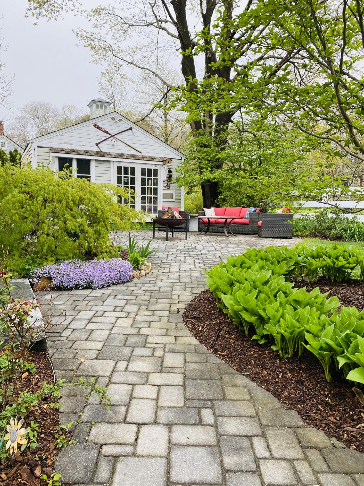 56 Sandwich Road Bourne, MA 02532 - Photo 8 of 31 a front view of a house with a yard and fountain
