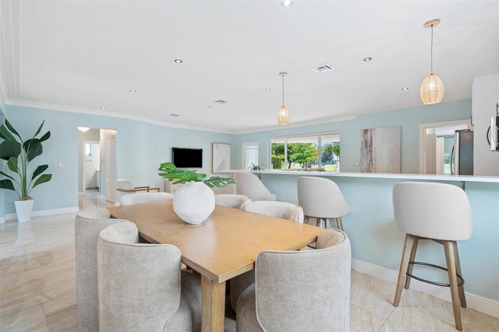 741 Fairway Drive Miami Beach, FL 33141 - Photo 11 of 50 a view of a dining room with furniture window and wooden floor