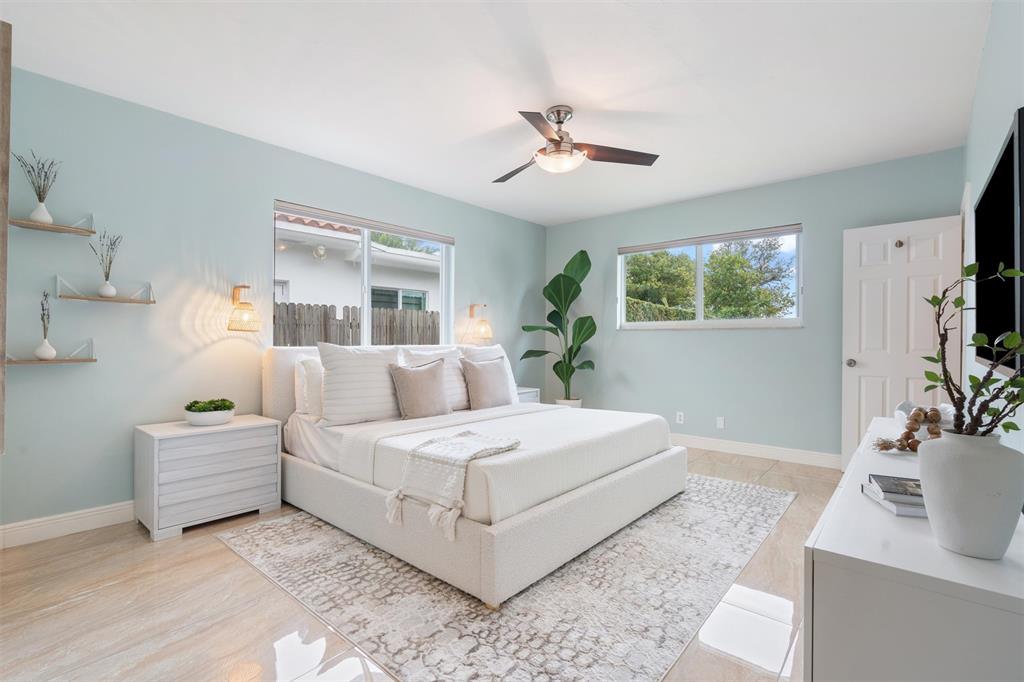 741 Fairway Drive Miami Beach, FL 33141 - Photo 12 of 50 a bedroom with a large bed and a flat screen tv