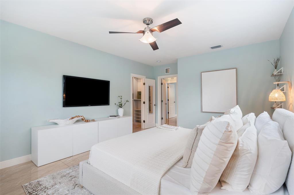 741 Fairway Drive Miami Beach, FL 33141 - Photo 13 of 50 a bedroom with a bed and a flat screen tv