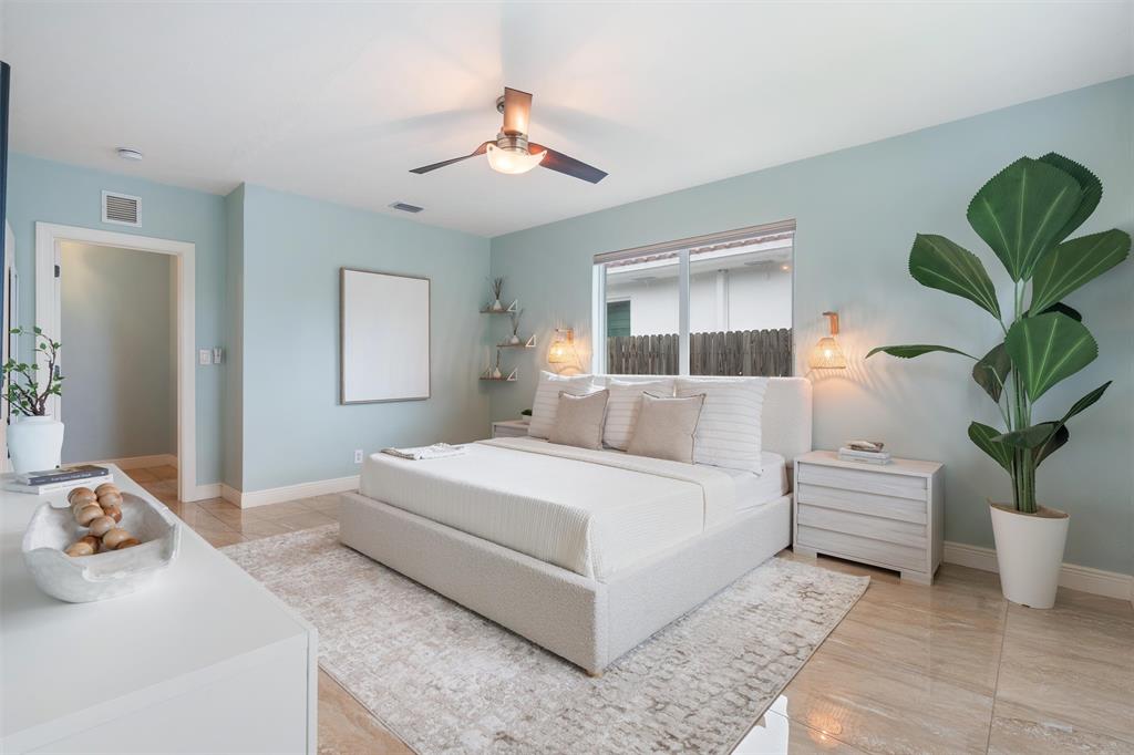 741 Fairway Drive Miami Beach, FL 33141 - Photo 14 of 50 a bedroom with a large bed and a couch