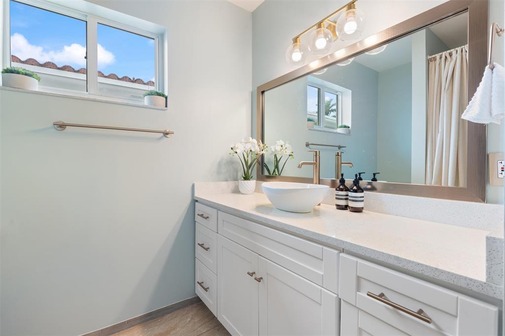 741 Fairway Drive Miami Beach, FL 33141 - Photo 25 of 50 a bathroom with a sink and a mirror