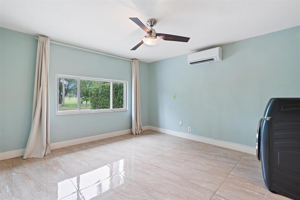 741 Fairway Drive Miami Beach, FL 33141 - Photo 27 of 50 an empty room with ceiling fan and windows