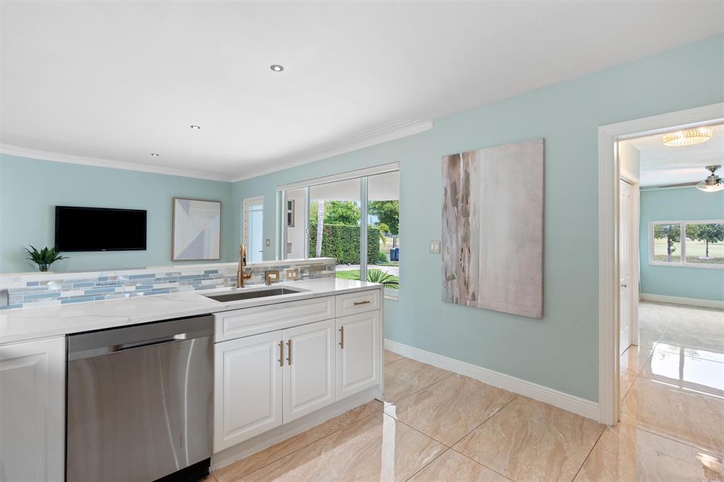 741 Fairway Drive Miami Beach, FL 33141 - Photo 3 of 50 a kitchen with a sink and cabinets