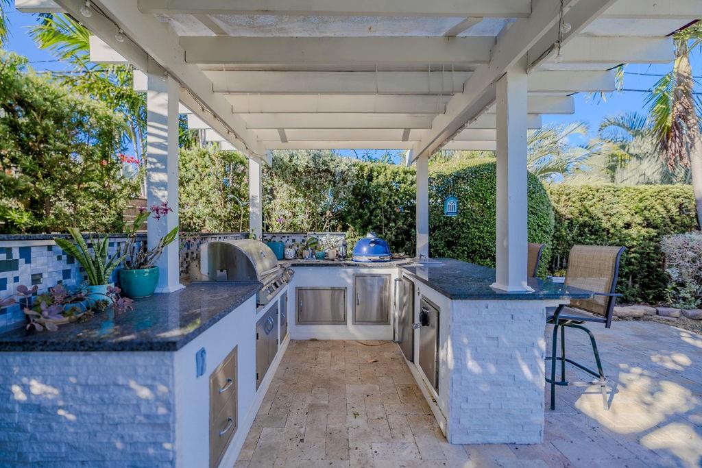 741 Fairway Drive Miami Beach, FL 33141 - Photo 34 of 50 a open kitchen with stainless steel appliances granite countertop a stove a sink and a chairs