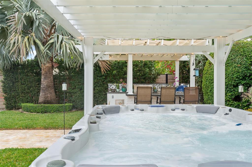 741 Fairway Drive Miami Beach, FL 33141 - Photo 37 of 50 a view of a patio with a table and chairs next to a yard