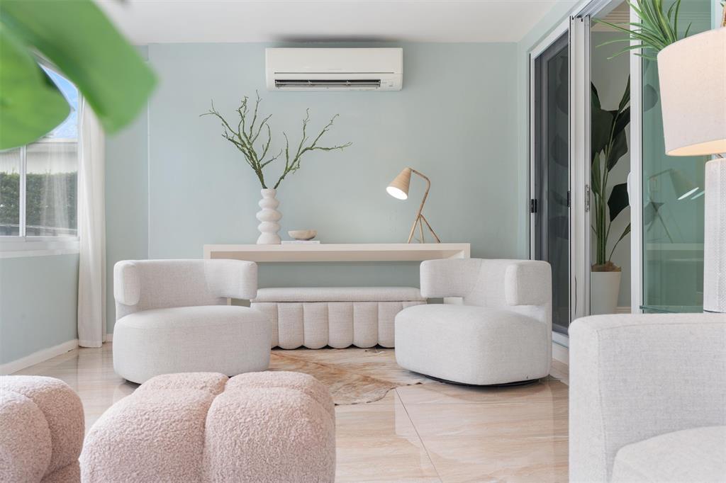 741 Fairway Drive Miami Beach, FL 33141 - Photo 6 of 50 a living room with furniture and a potted plant