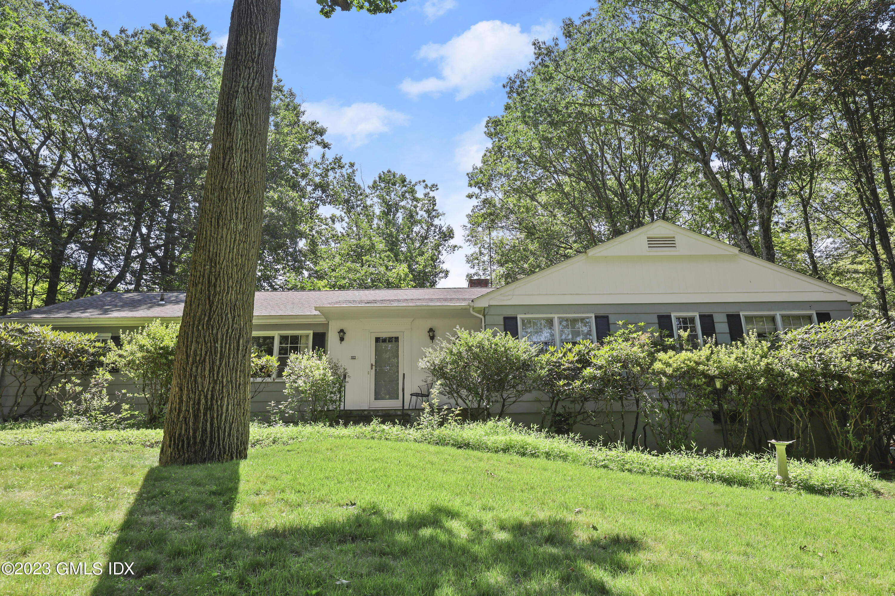 10 Woodchuck Road Stamford, CT 06903 - Photo 1 of 28 a front view of house with yard and green space