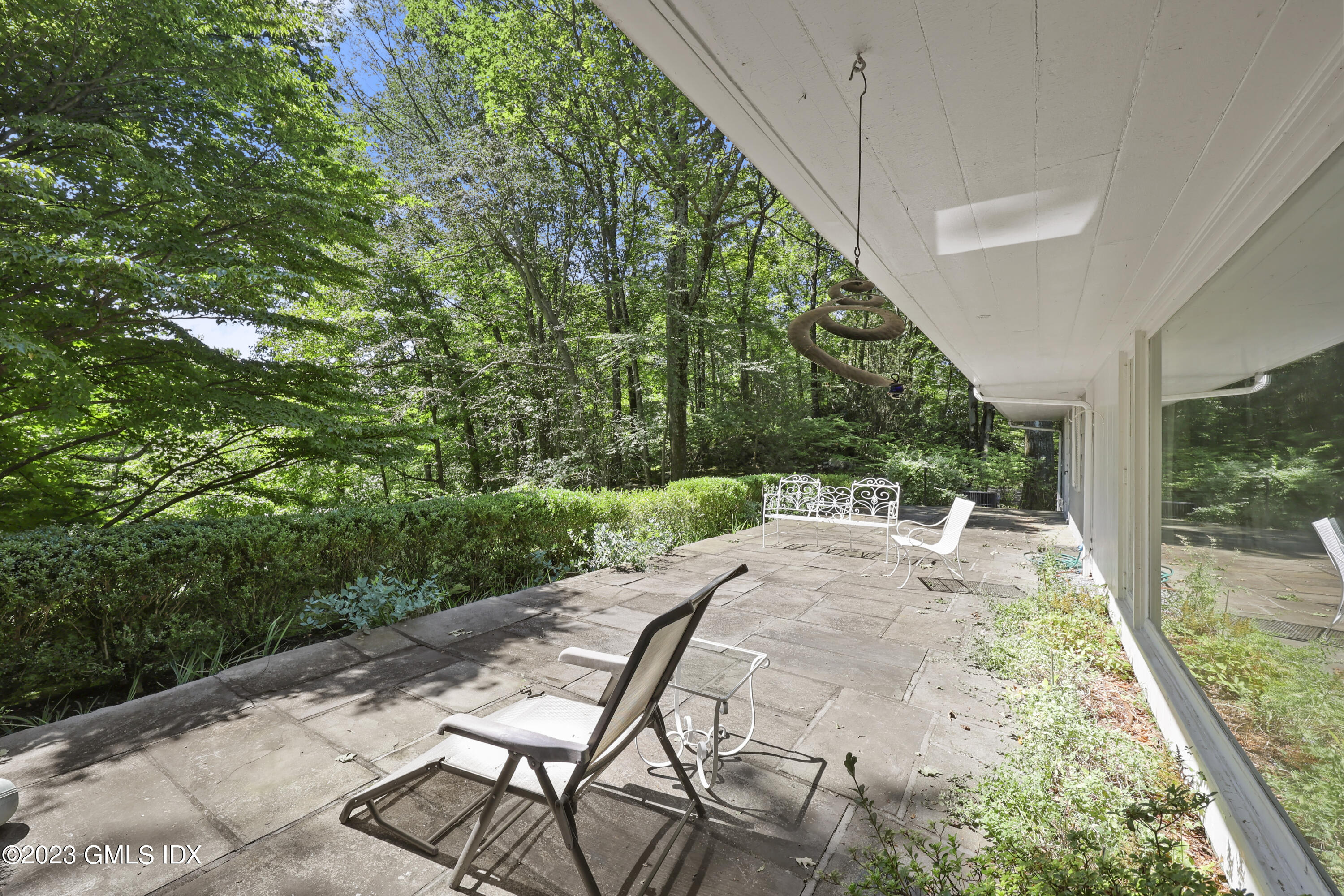 10 Woodchuck Road Stamford, CT 06903 - Photo 3 of 28 a view of a backyard with sitting area
