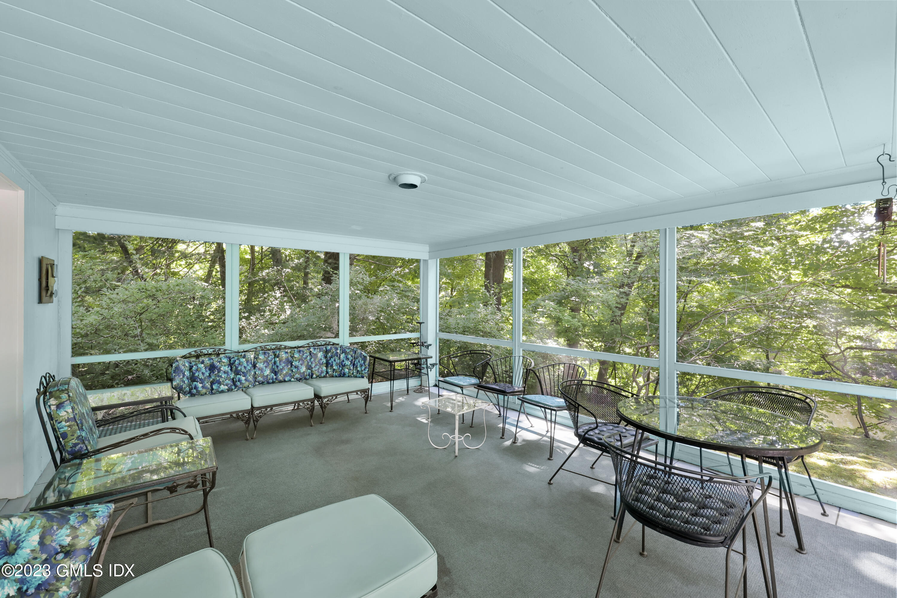 10 Woodchuck Road Stamford, CT 06903 - Photo 10 of 28 a living room with furniture and a floor to ceiling window