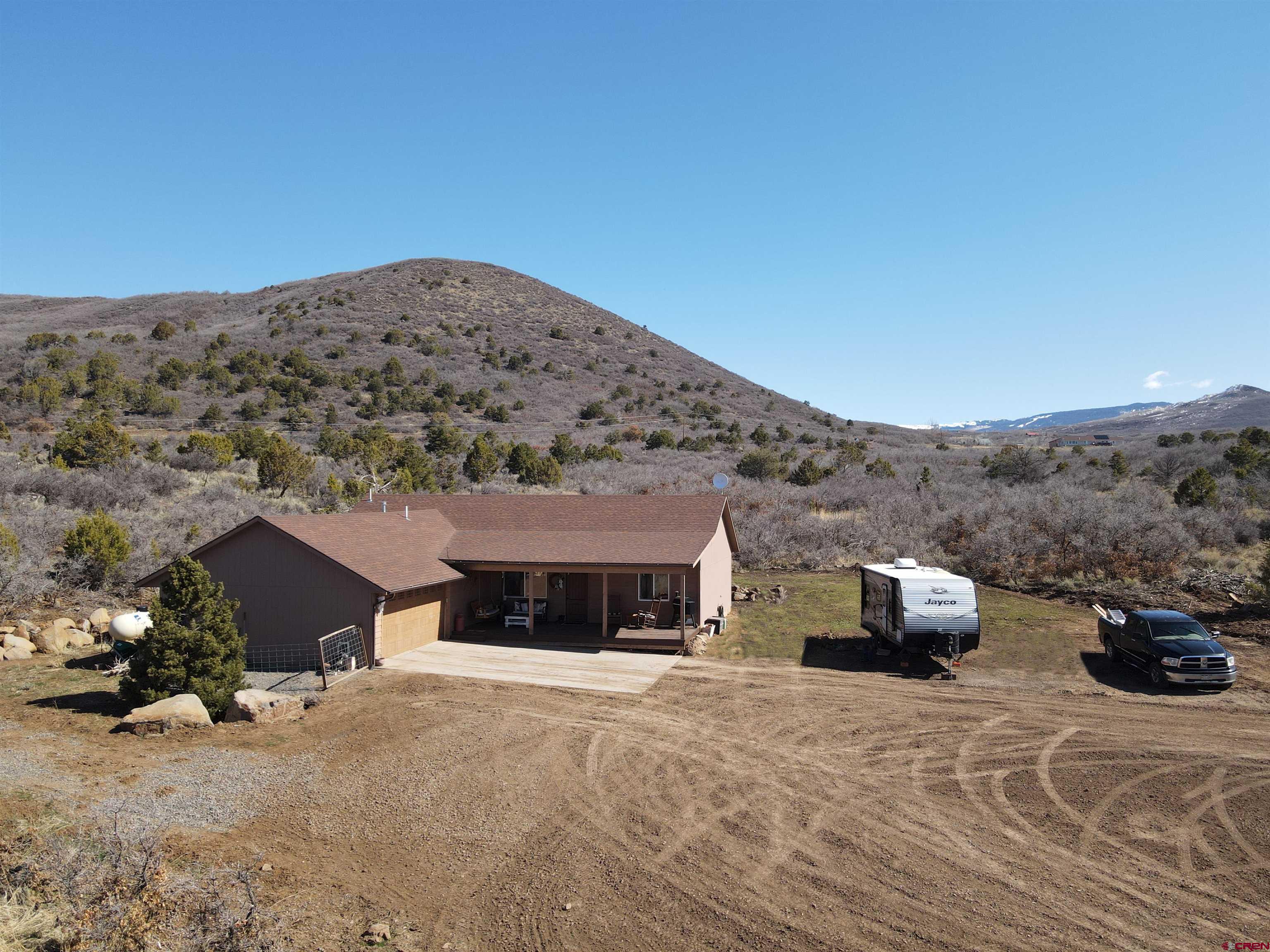 25463 Vail Road Cedaredge, CO 81413 - Photo 1 of 28 a front view of a house with a yard