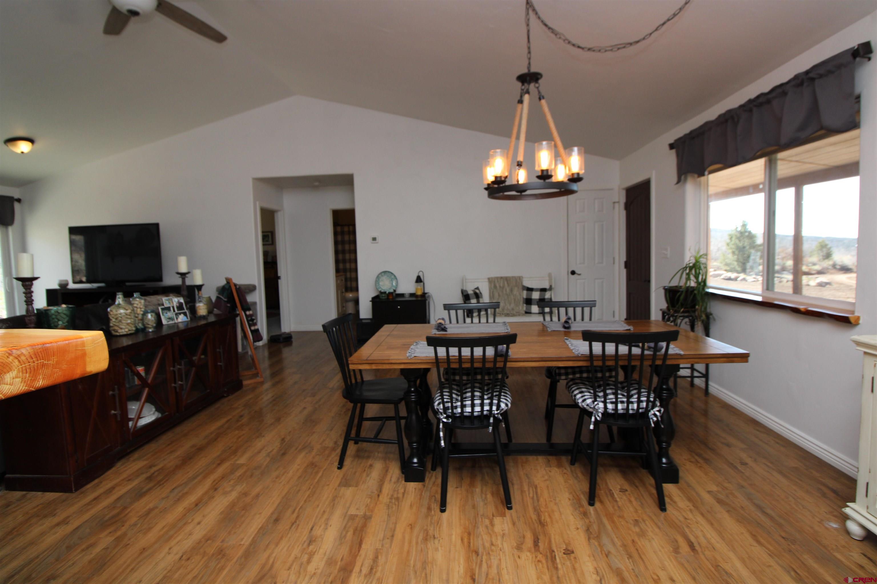 25463 Vail Road Cedaredge, CO 81413 - Photo 13 of 28 a view of a dining room with furniture window and wooden floor