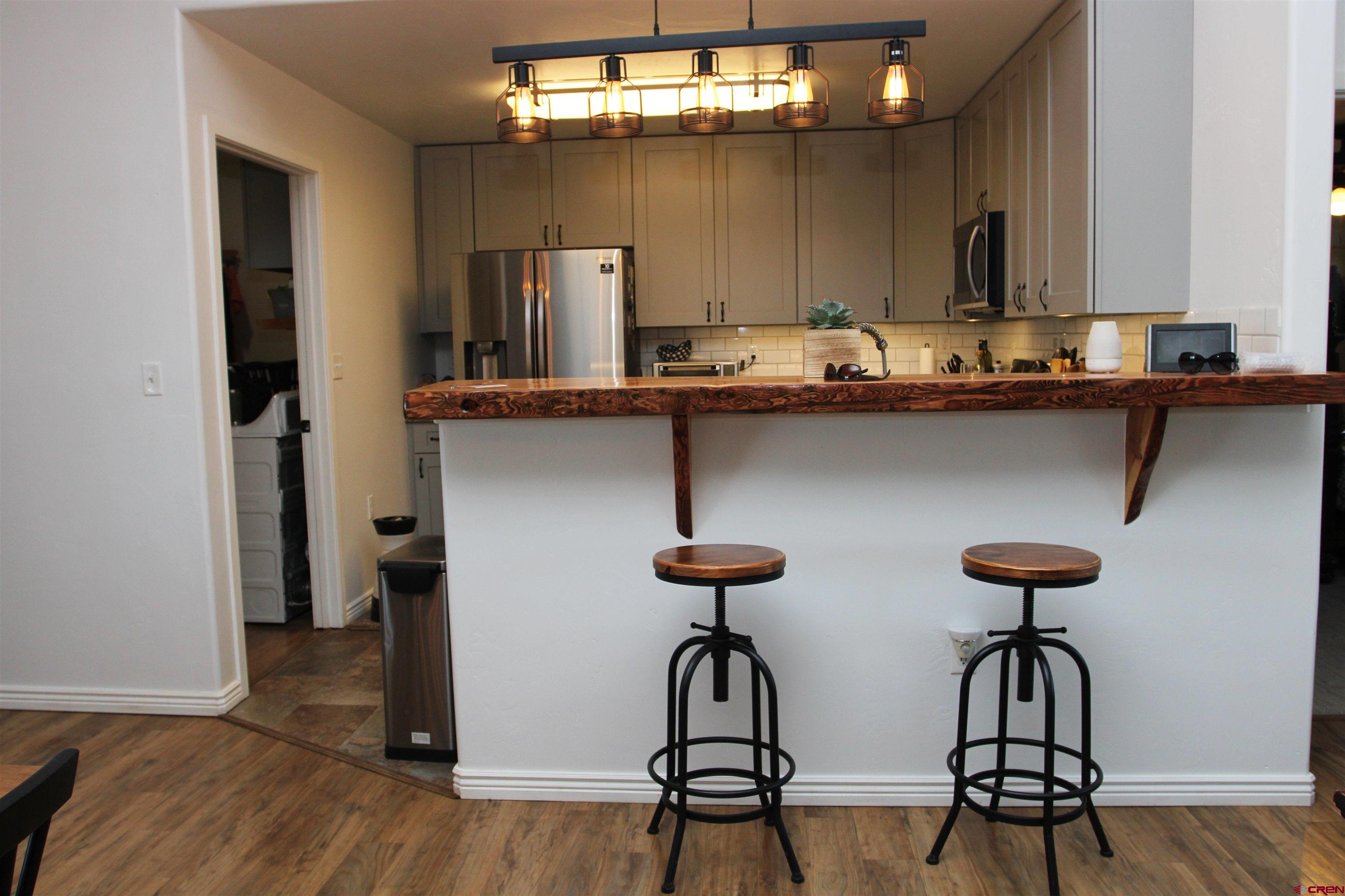 25463 Vail Road Cedaredge, CO 81413 - Photo 14 of 28 a view of hall way with furniture and wooden floor