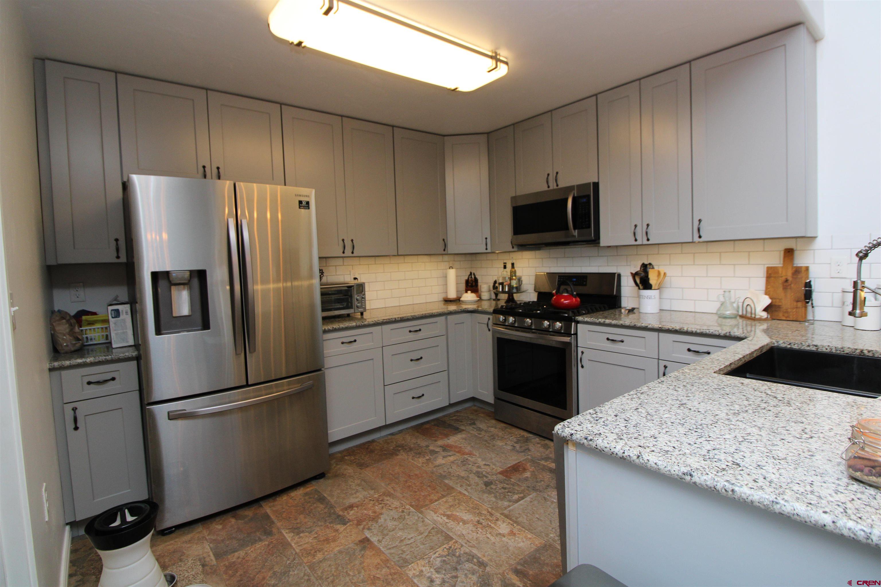 25463 Vail Road Cedaredge, CO 81413 - Photo 17 of 28 a kitchen with a refrigerator sink and microwave