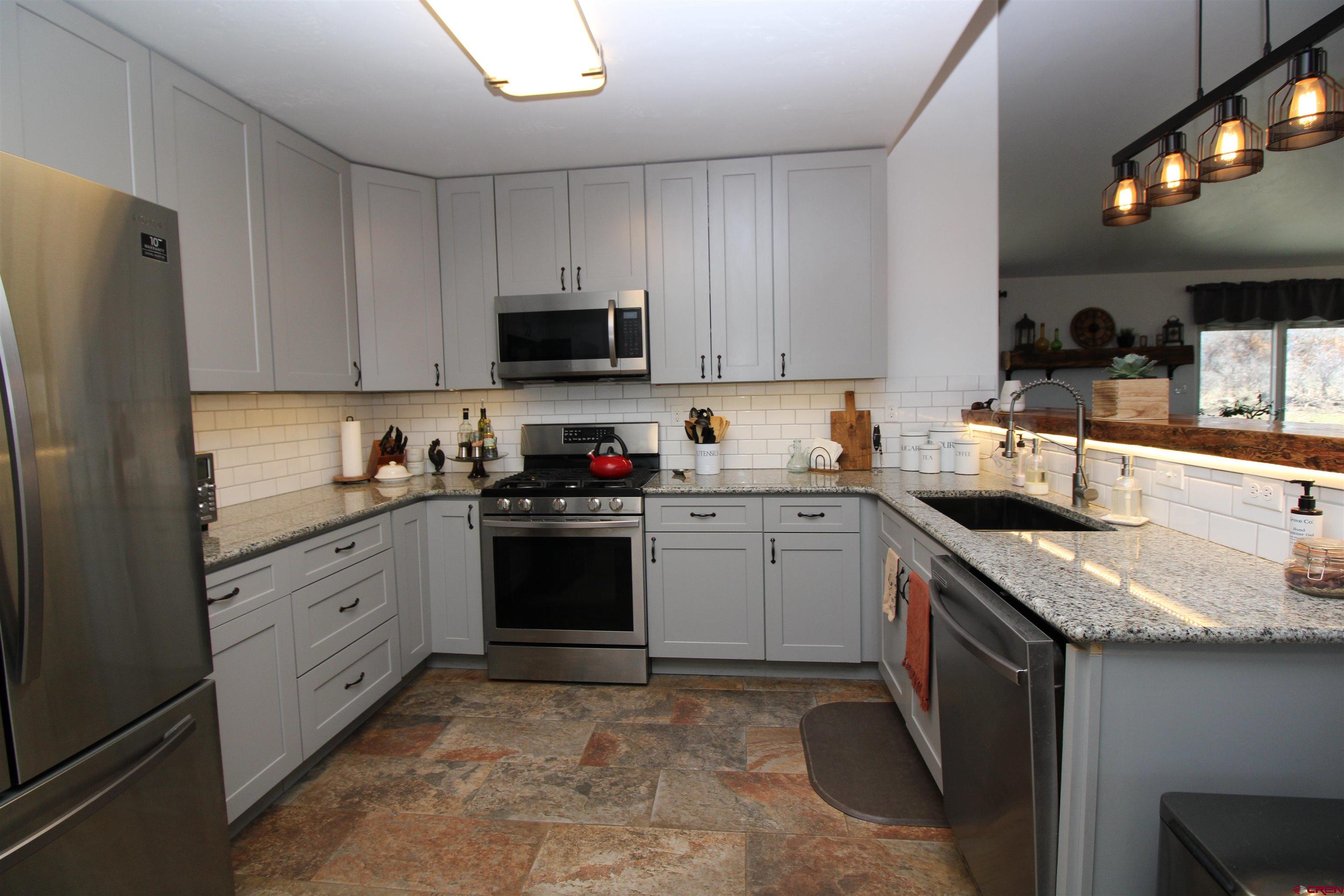 25463 Vail Road Cedaredge, CO 81413 - Photo 18 of 28 a kitchen with a sink stove and refrigerator