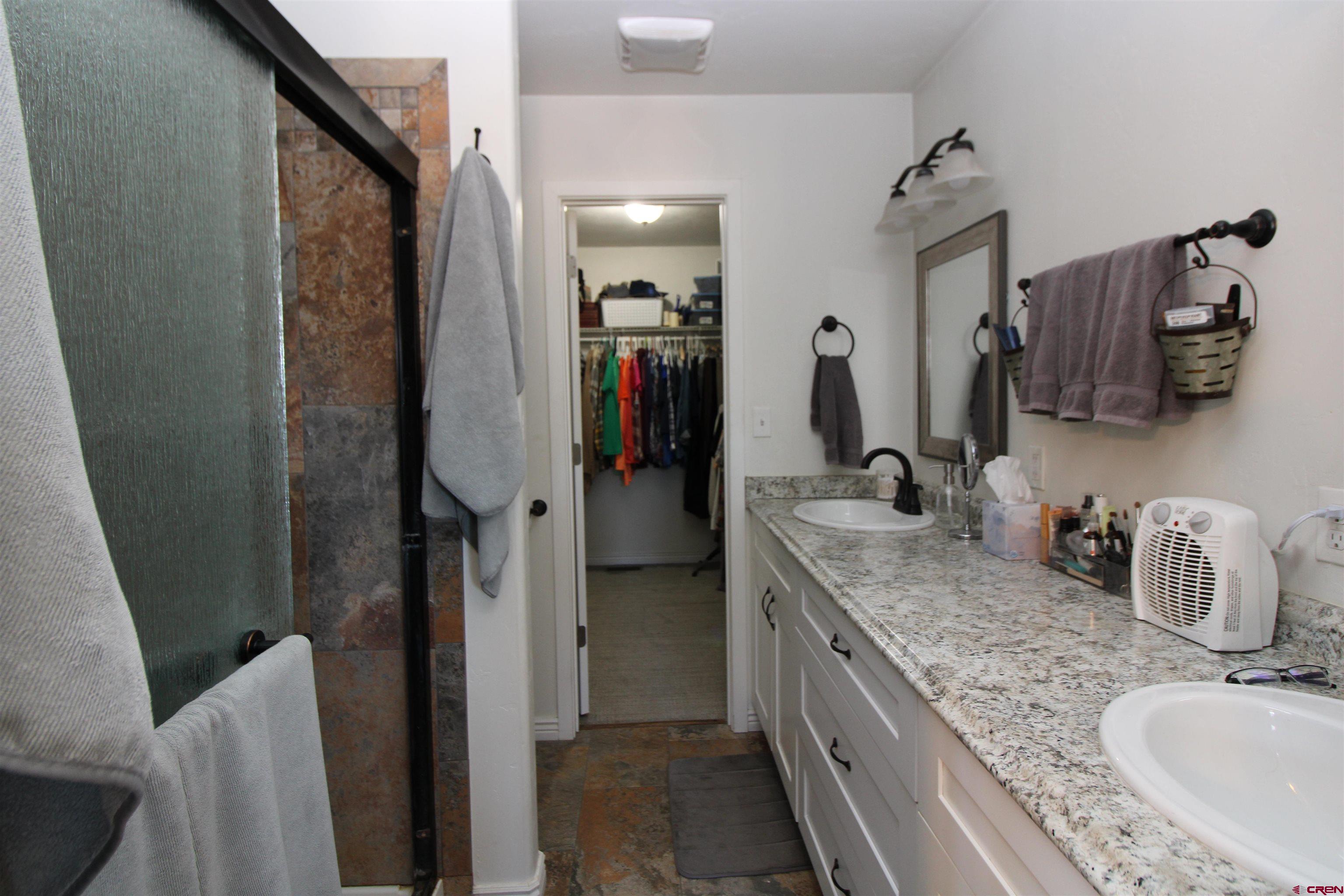 25463 Vail Road Cedaredge, CO 81413 - Photo 22 of 28 a bathroom with a granite countertop sink and a mirror