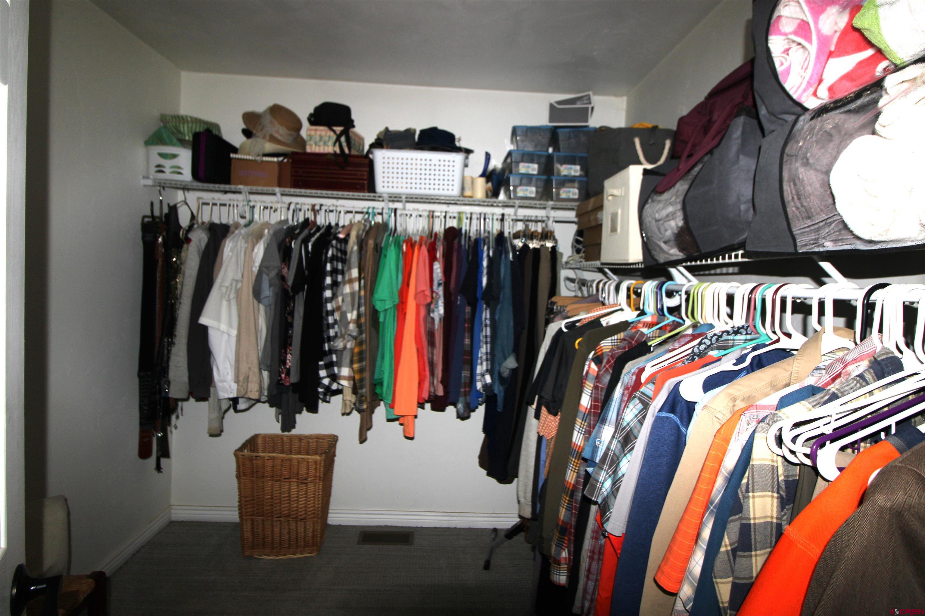 25463 Vail Road Cedaredge, CO 81413 - Photo 23 of 28 a view of walk in closet with clothes and shoes