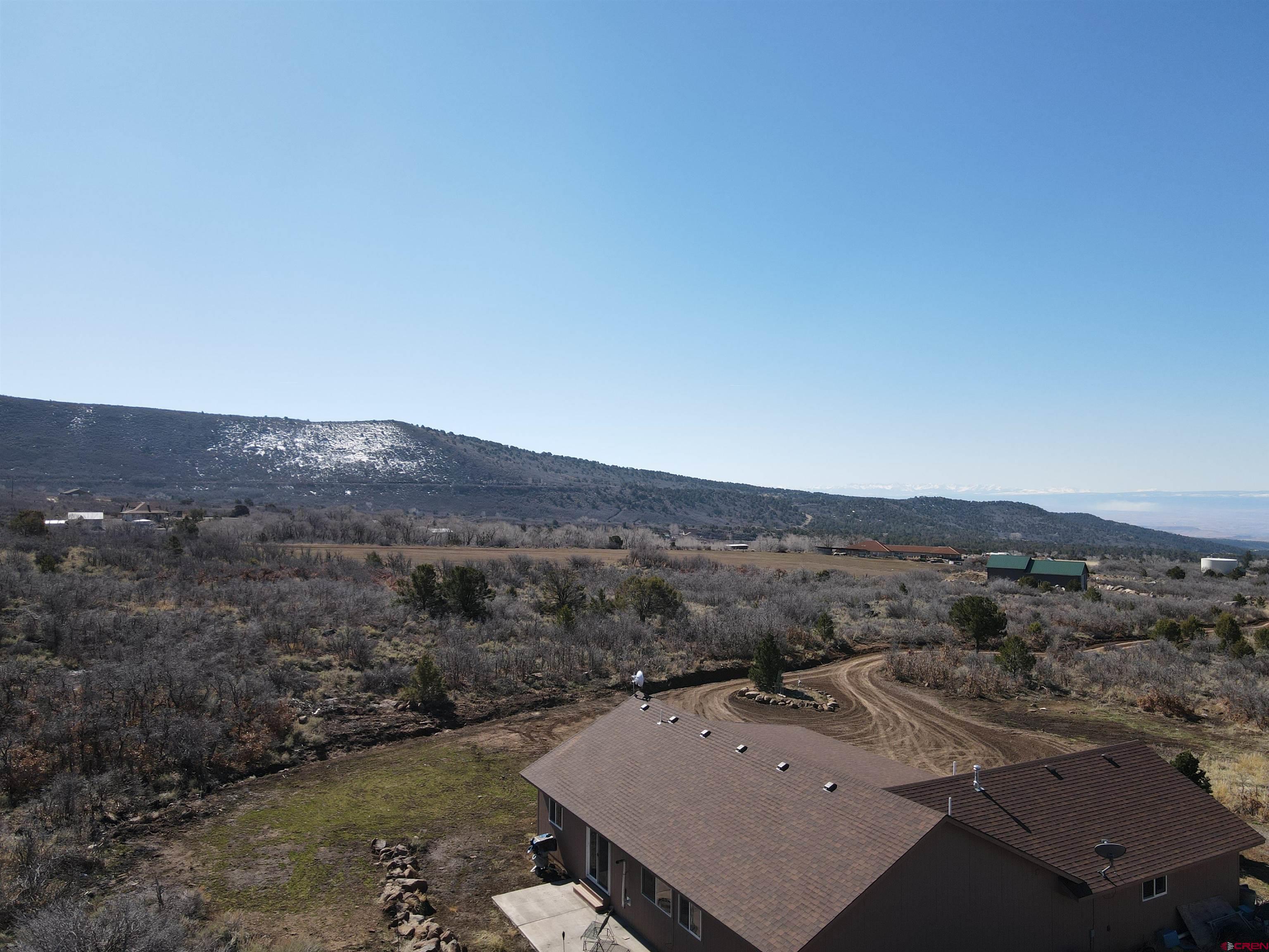 25463 Vail Road Cedaredge, CO 81413 - Photo 3 of 28 an aerial view of residential house and outdoor space