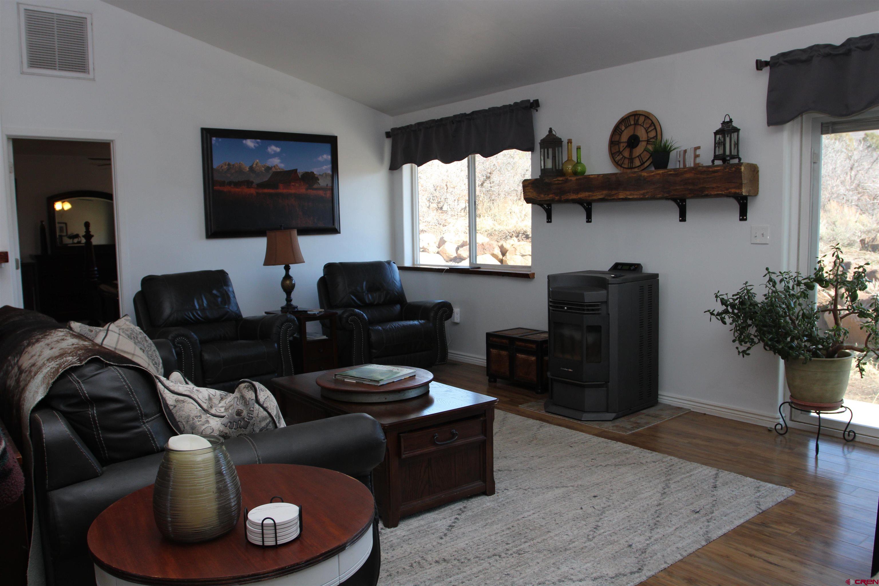 25463 Vail Road Cedaredge, CO 81413 - Photo 6 of 28 a living room with furniture and a fireplace