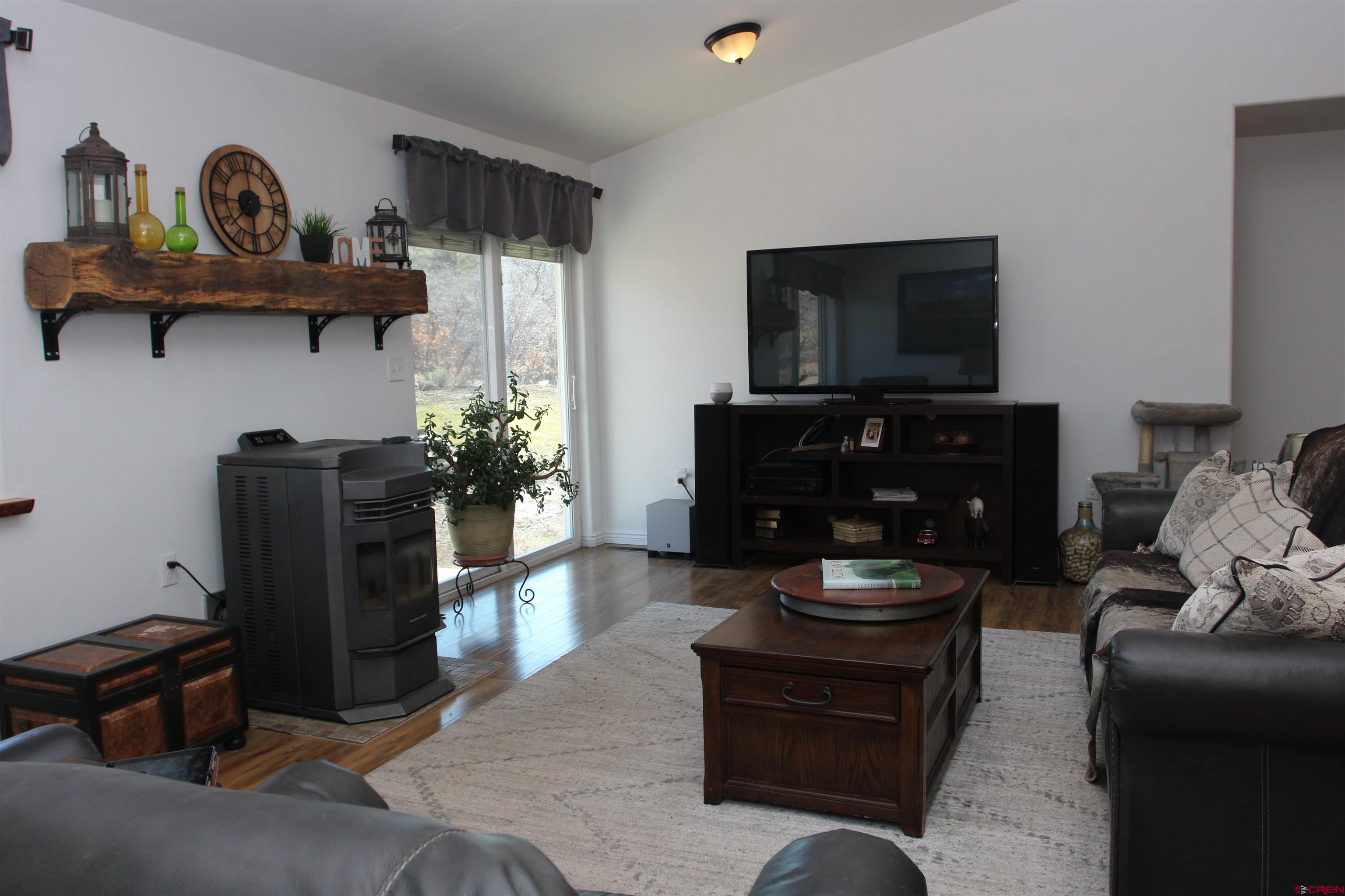 25463 Vail Road Cedaredge, CO 81413 - Photo 7 of 28 a living room with furniture and a flat screen tv