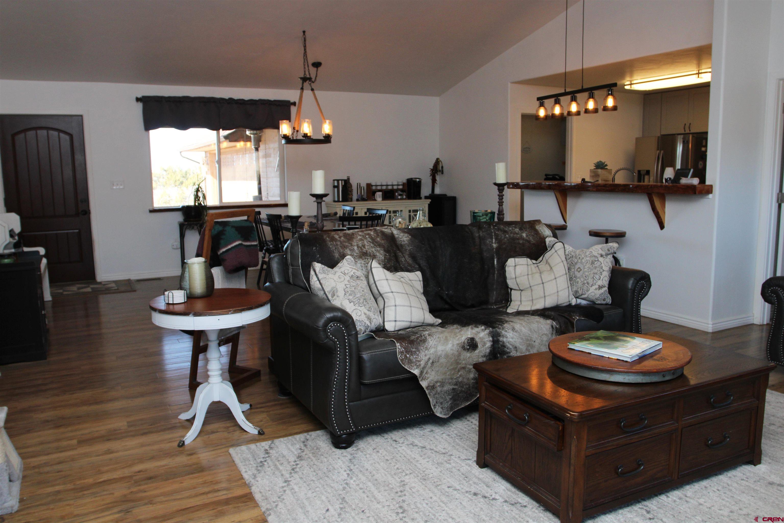 25463 Vail Road Cedaredge, CO 81413 - Photo 9 of 28 a living room with furniture a window and kitchen view