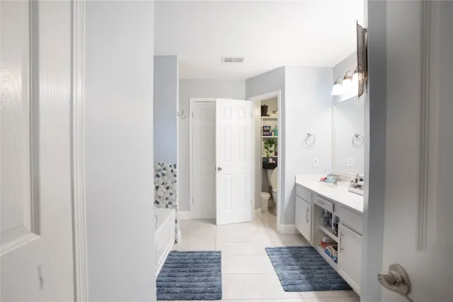 a bathroom with a sink a mirror and a shower