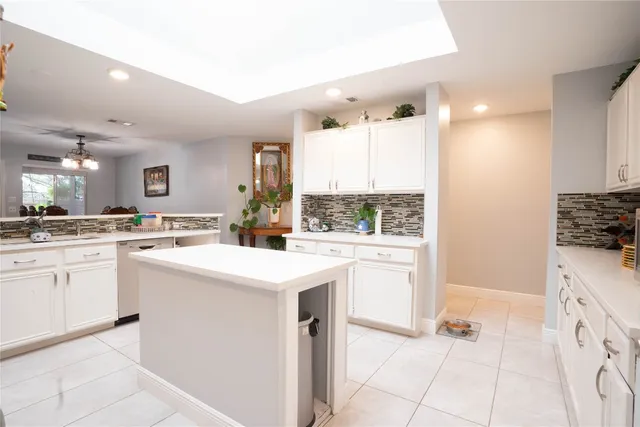 a kitchen with a sink stove and white cabinets