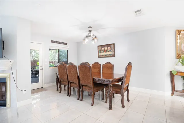 a view of a dining room with furniture and chandelier