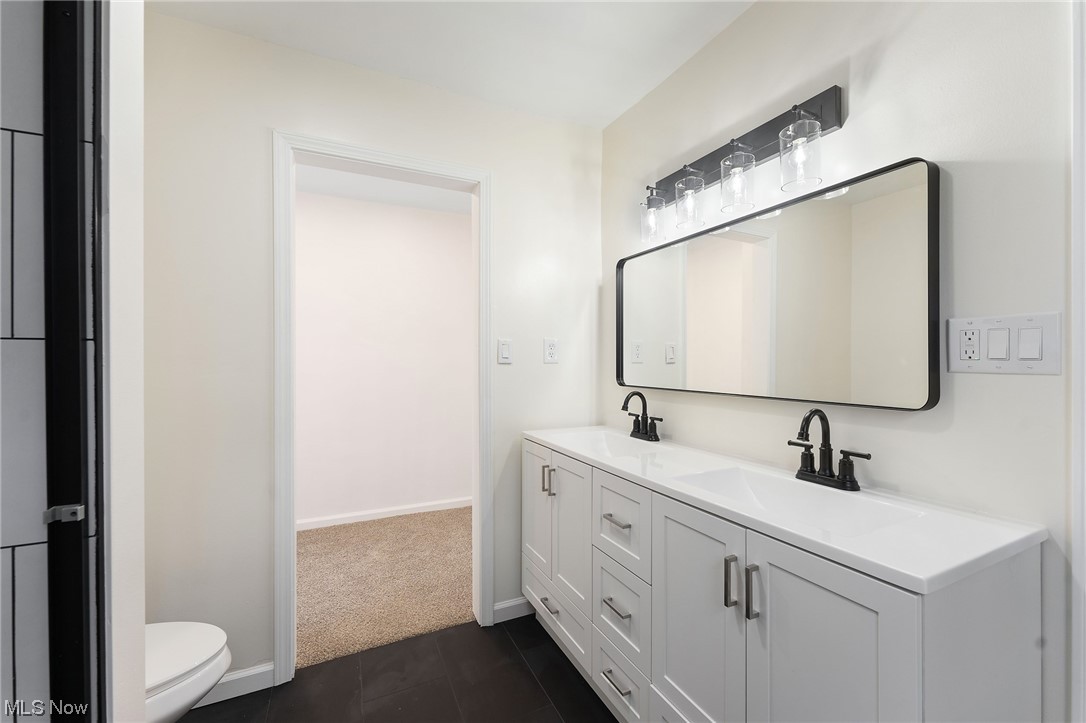 1707 Brookfield Road Hubbard, OH 44425 - Photo 21 of 30 Bathroom with double vanity, toilet, and tile floors
