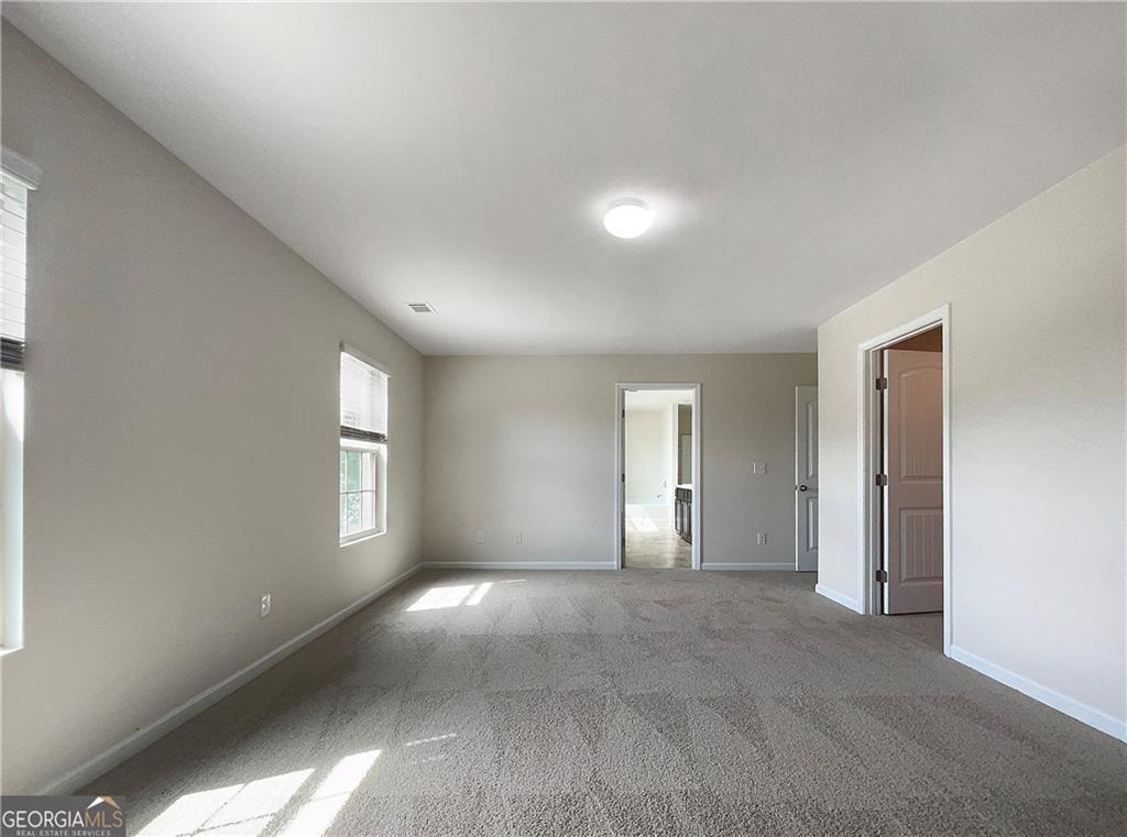 1033 Eldon Lane Fairburn, GA 30213 - Photo 15 of 21 a view of empty room with windows