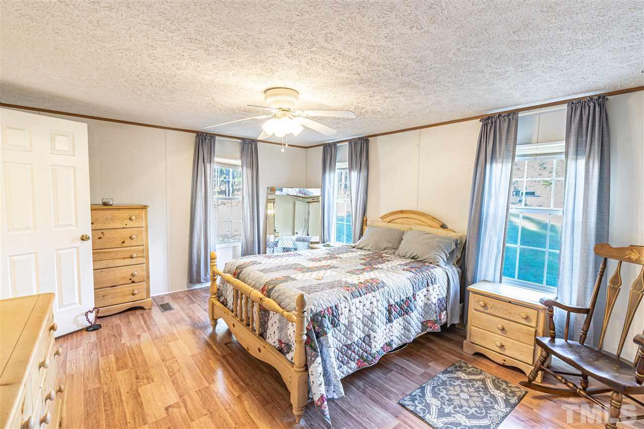 72 Cypress Farm Road Cameron, NC 28326 - Photo 14 of 28 a bedroom with a bed and wooden floor