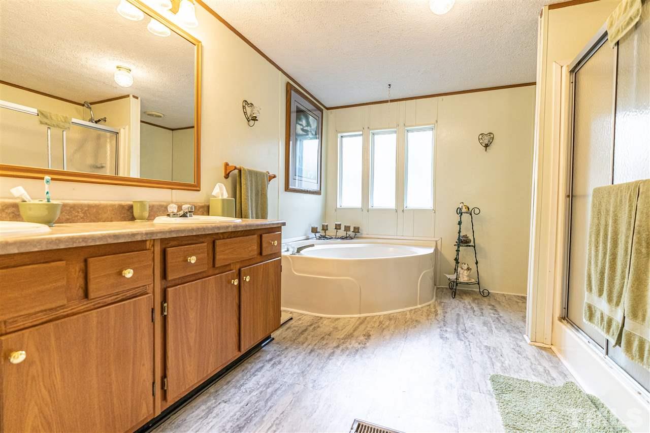 72 Cypress Farm Road Cameron, NC 28326 - Photo 16 of 28 a spacious bathroom with a double vanity sink a mirror and a bathtub