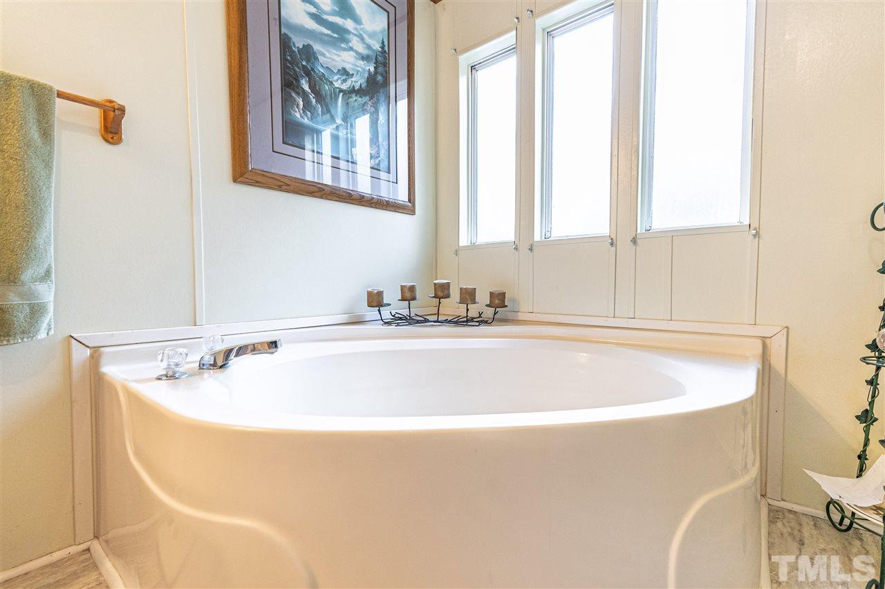 72 Cypress Farm Road Cameron, NC 28326 - Photo 17 of 28 a white bath tub sitting next to a window