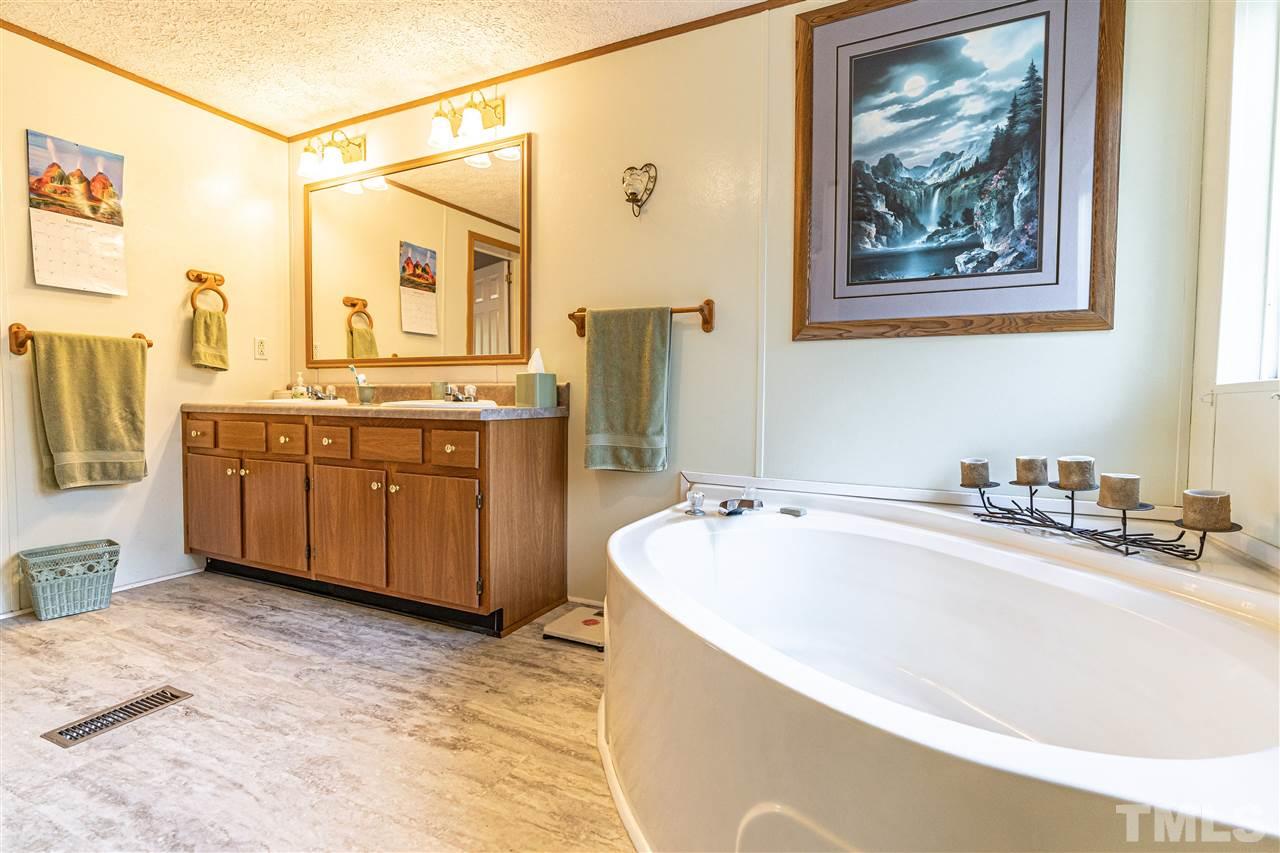 72 Cypress Farm Road Cameron, NC 28326 - Photo 18 of 28 a spacious bathroom with a tub a sink and mirror